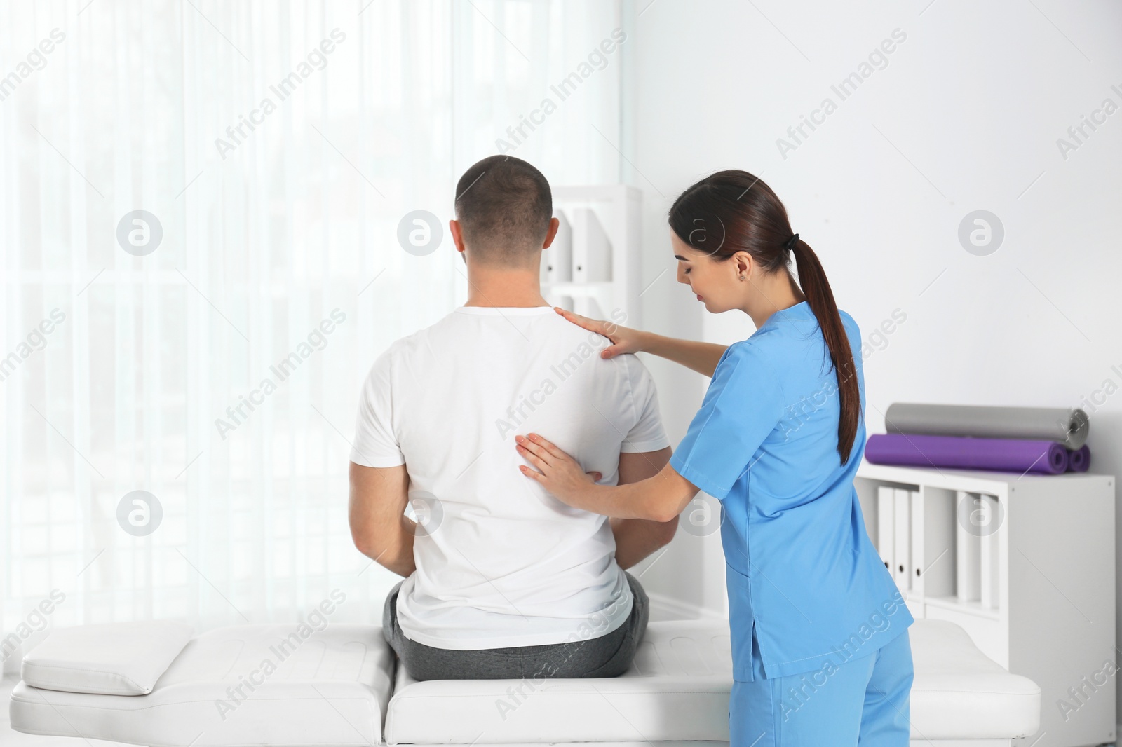 Photo of Doctor working with patient in hospital. Rehabilitation massage