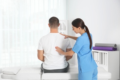 Photo of Doctor working with patient in hospital. Rehabilitation massage