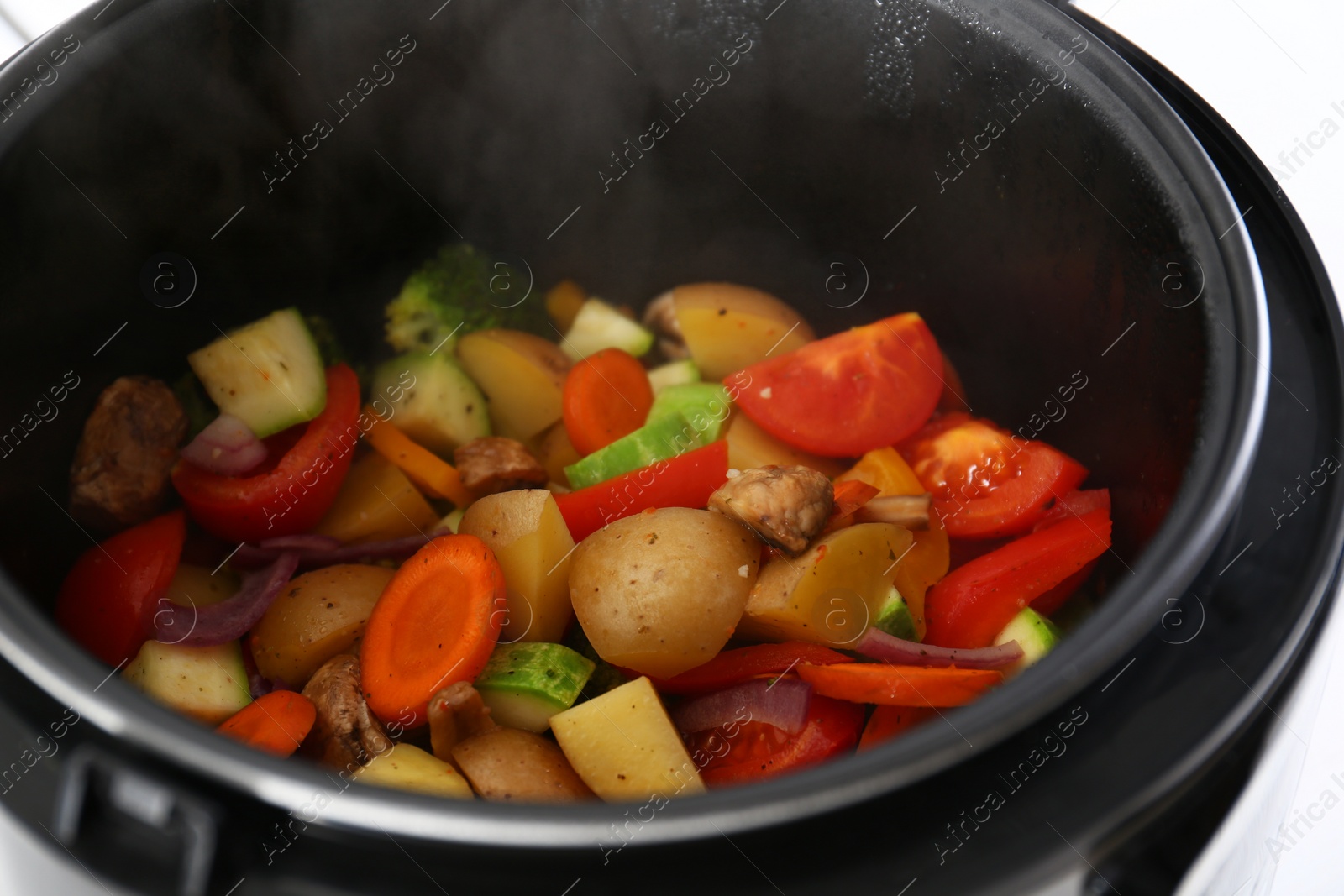 Photo of Closeup view of multi cooker with vegetables