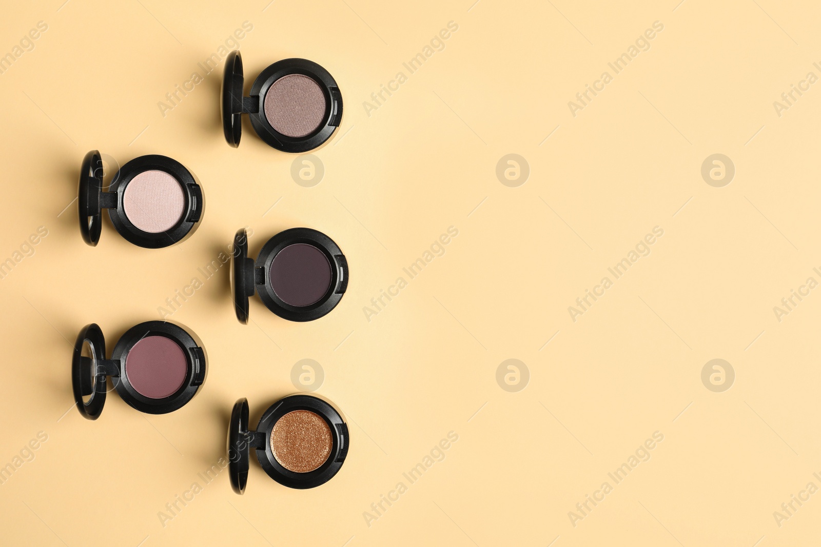 Photo of Flat lay composition with different eye shadows on color background. Space for text