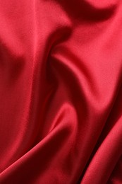 Texture of beautiful red silk fabric as background, closeup