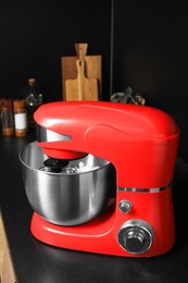 Photo of Modern red stand mixer on countertop in kitchen