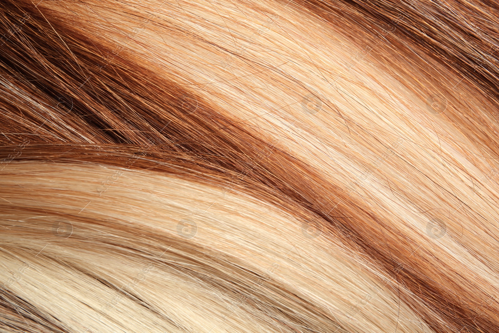 Photo of Strands of different color hair as background, closeup