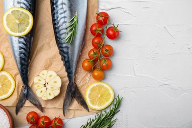 Photo of Tasty raw mackerel and ingredients on white textured table, flat lay. Space for text