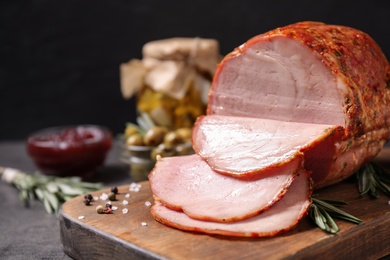 Photo of Delicious cooked ham served on wooden board