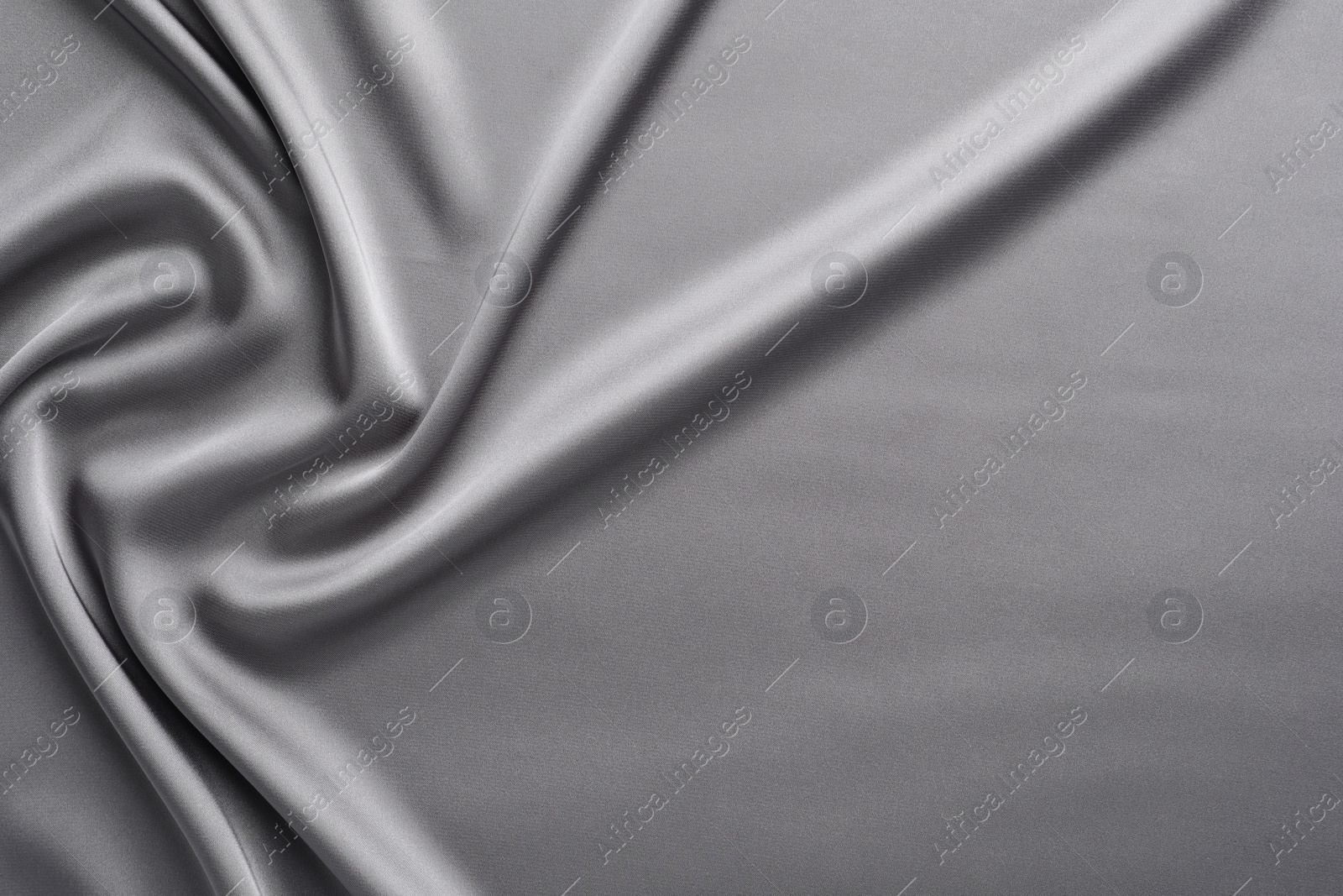 Photo of Texture of beautiful light grey silk fabric as background, closeup