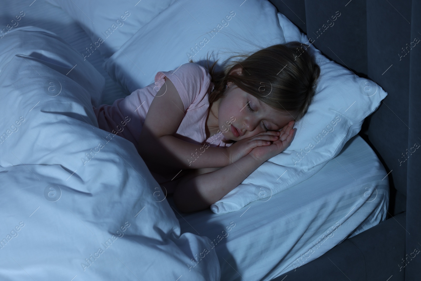 Photo of Little girl snoring while sleeping in bed at home