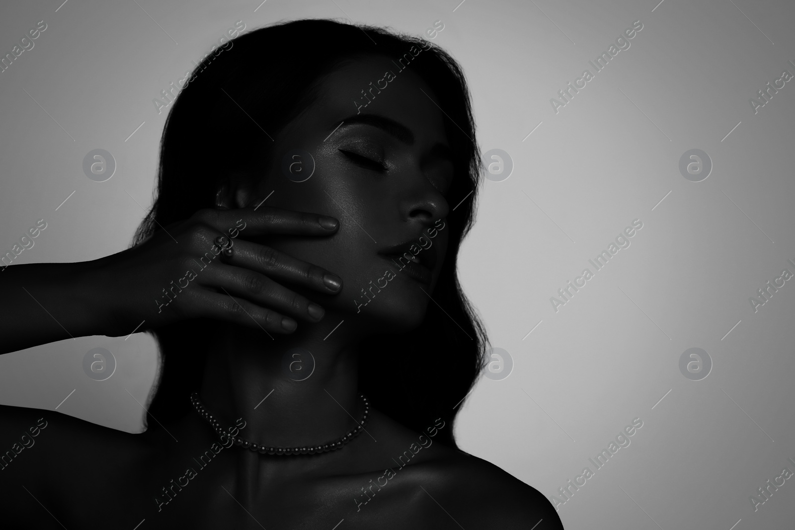 Image of Silhouette of one woman on light grey background, space for text