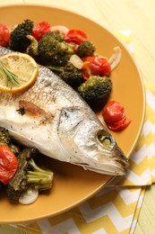 Photo of Delicious baked fish and vegetables on table