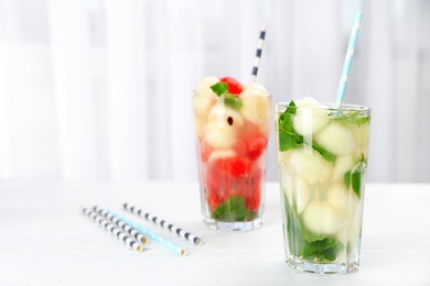 Tasty watermelon and melon ball drink in glasses on table