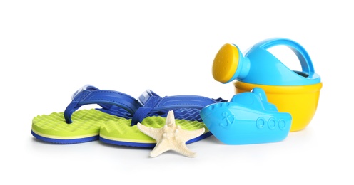 Photo of Set of plastic beach toys and flippers on white background