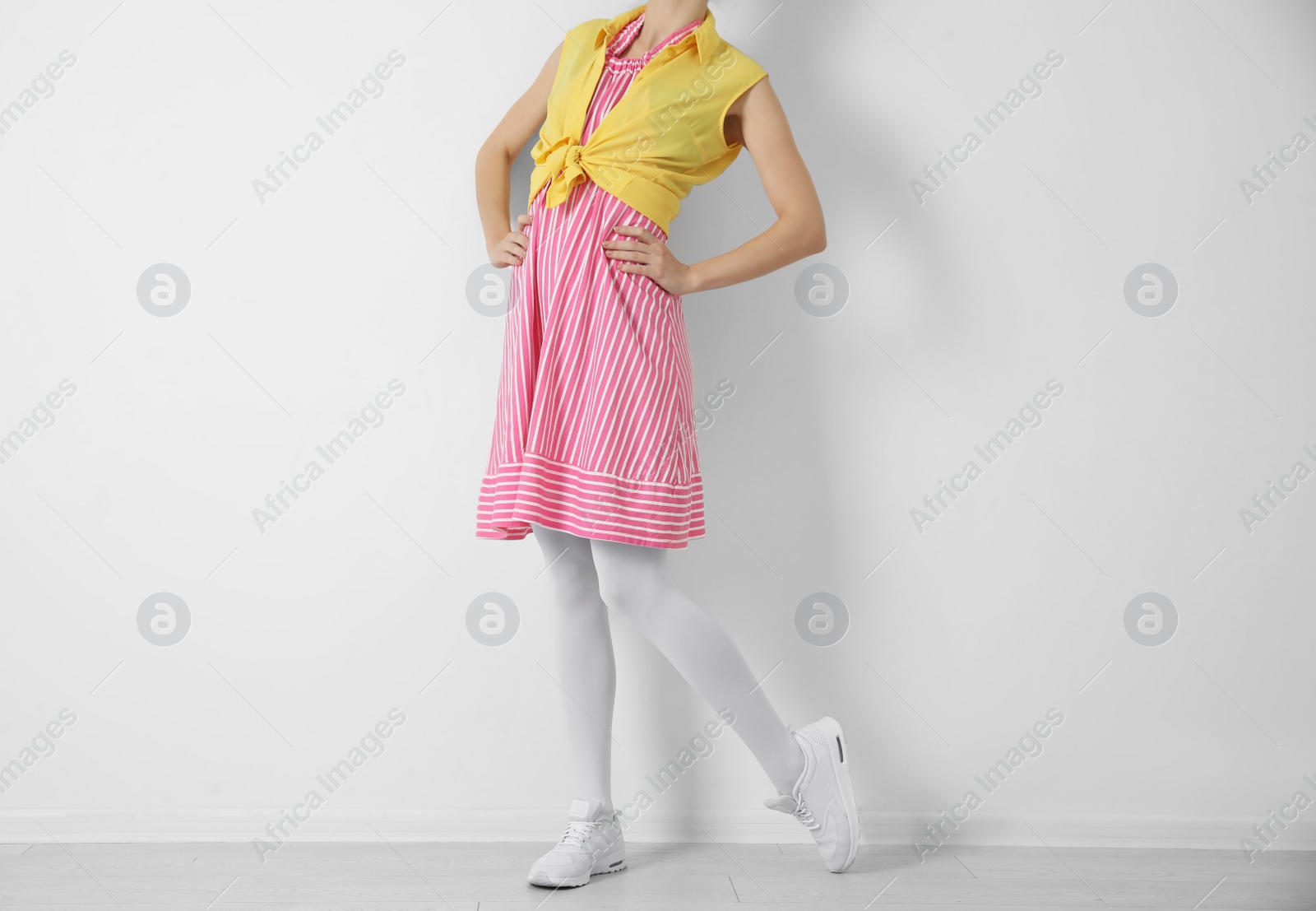 Photo of Woman wearing tights near white wall, closeup