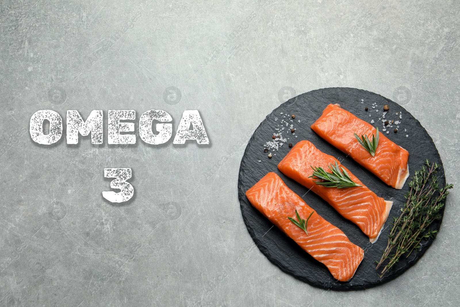 Image of Omega 3. Fresh cut salmon, herbs and spices on grey table, top view