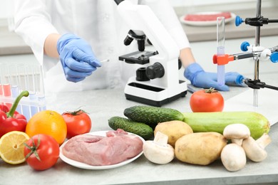 Photo of Scientist checking products at table in laboratory, closeup. Quality control