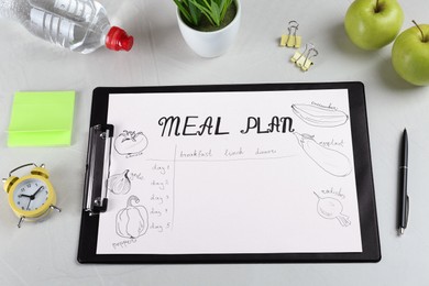 Composition of clipboard with Meal Plan on light grey table, above view