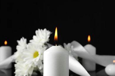 Burning candle in darkness, closeup with space for text. Funeral symbol