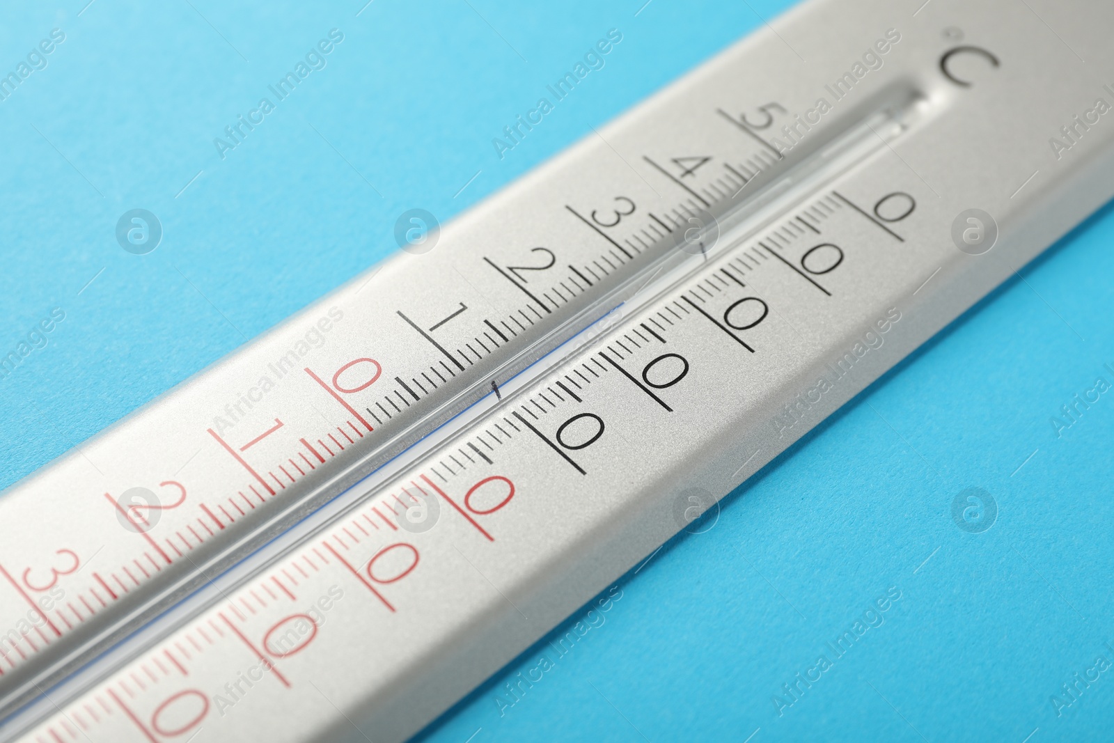 Photo of Weather thermometer on light blue background, closeup