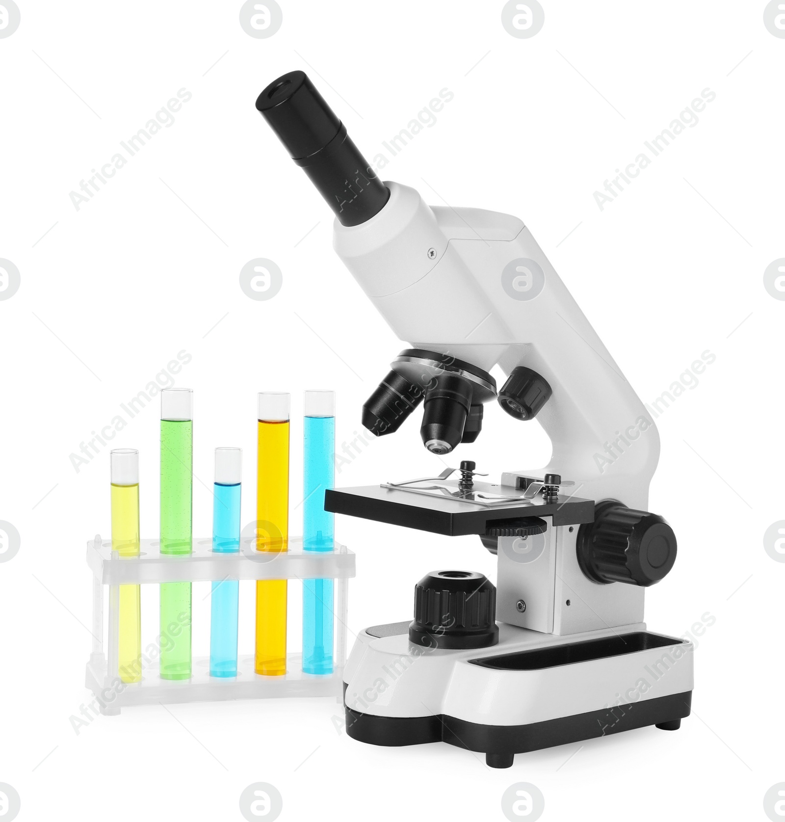 Photo of Test tubes with colorful liquids and microscope isolated on white