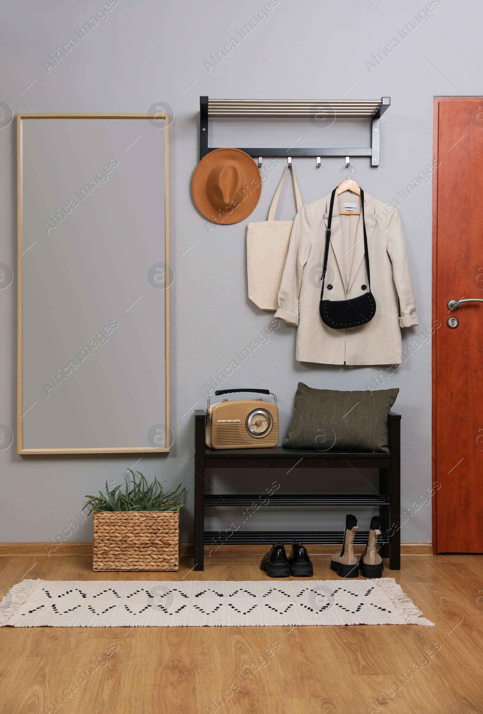 Photo of Modern hallway interior with shoe rack and mirror