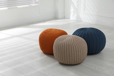 Different stylish poufs in room. Home design