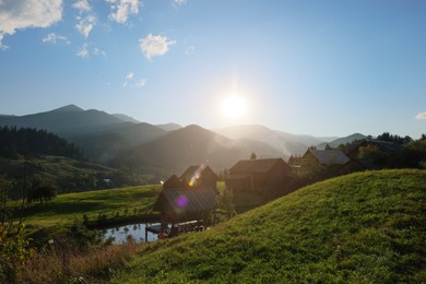 Photo of Morning sun shining over village in mountains