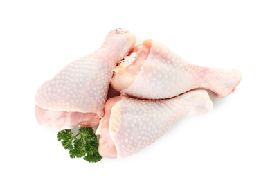 Photo of Raw chicken drumsticks with parsley on white background, top view. Fresh meat