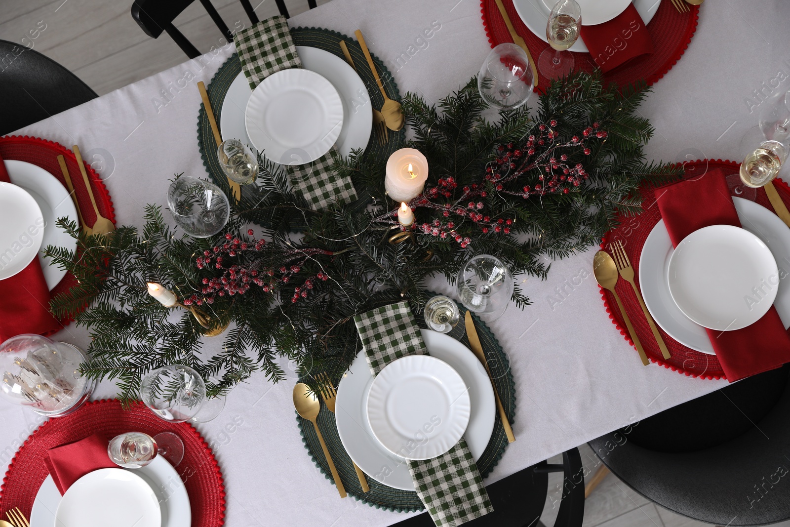 Photo of Christmas table setting with festive decor and dishware, top view