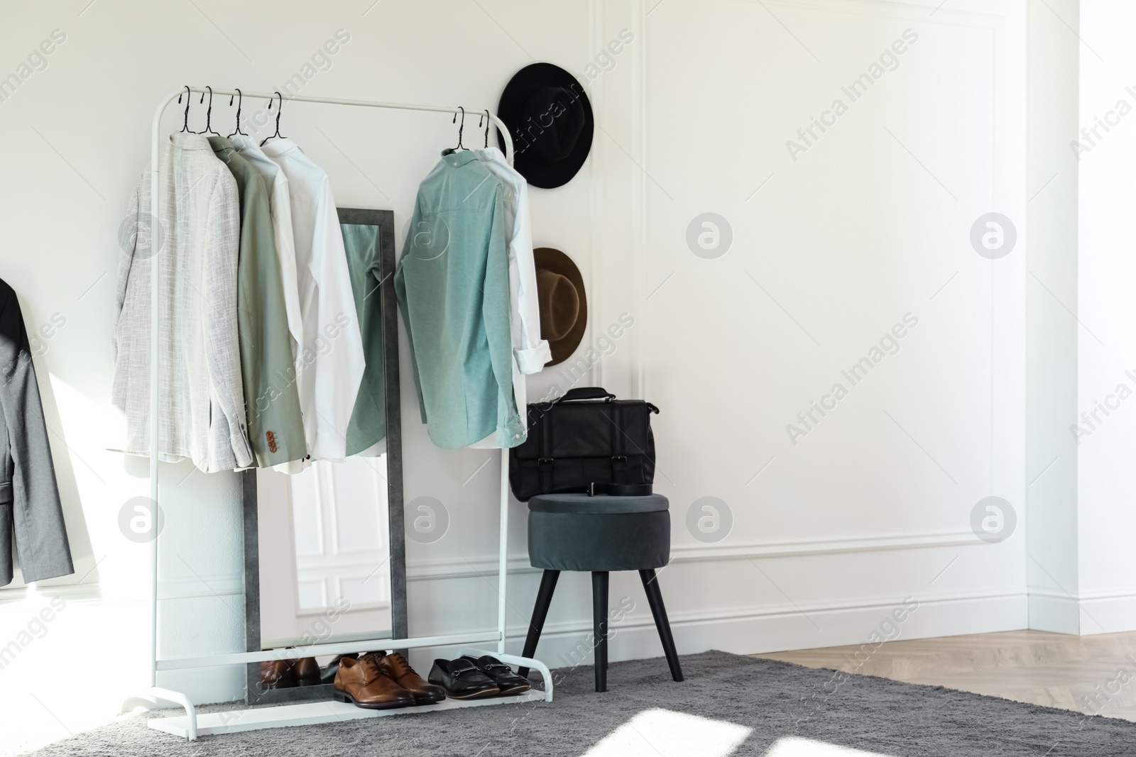 Photo of Rack with stylish clothes in modern dressing room