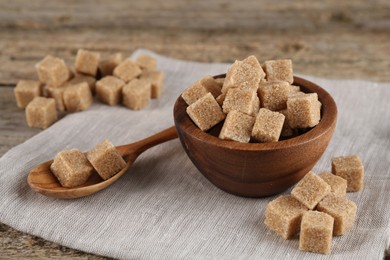 Photo of Many brown sugar cubes on table, closeup