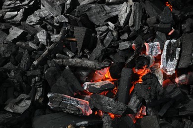 Photo of Many smoldering coals as background, top view