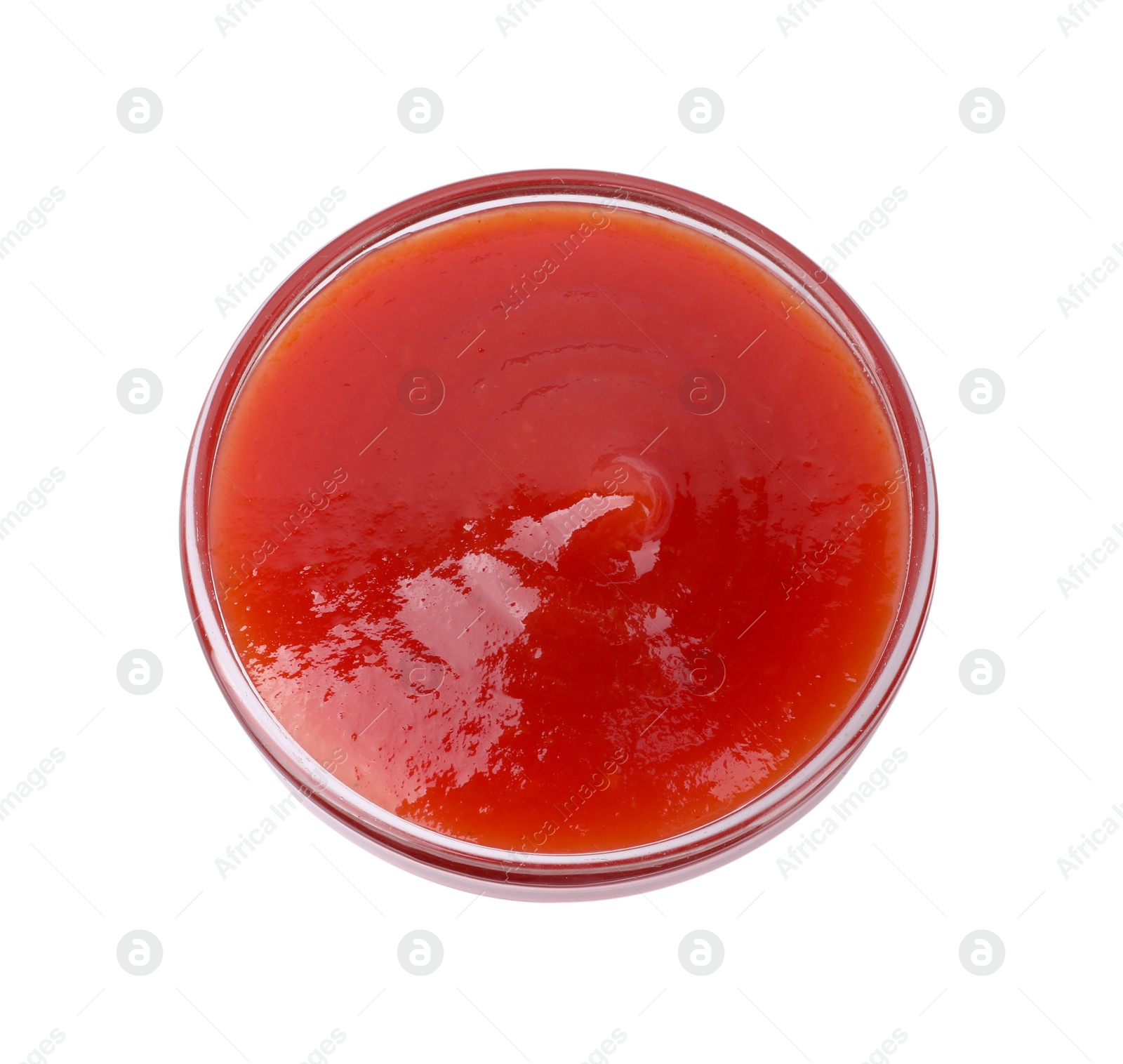 Photo of Organic ketchup in glass bowl isolated on white, top view. Tomato sauce