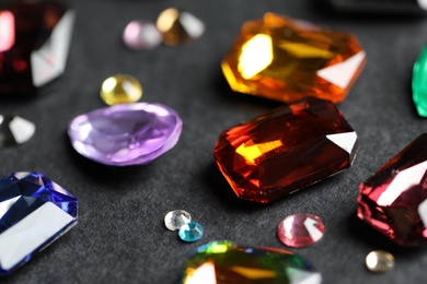 Beautiful gemstones for jewelry on dark background, closeup