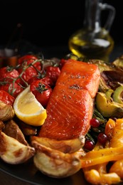 Tasty cooked salmon and vegetables on plate, closeup. Healthy meals from air fryer