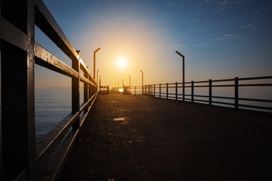 Photo of Picturesque view of empty pier at sunrise