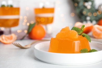 Delicious tangerine jelly with mint on white table