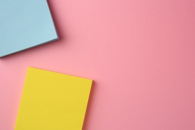 Photo of Blank paper notes on pink background, flat lay. Space for text