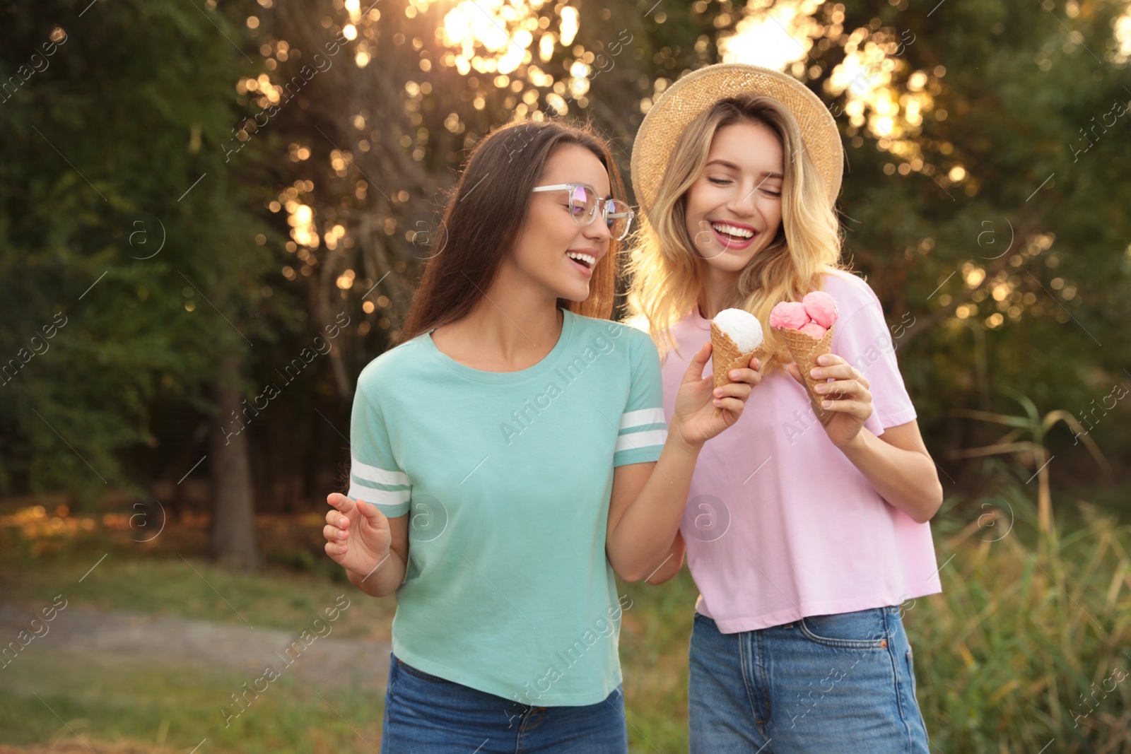 Photo of Young women with ice cream spending time together outdoors