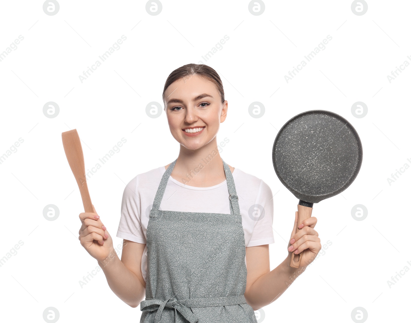 Photo of Beautiful young woman in striped apron with kitchen tools on white background