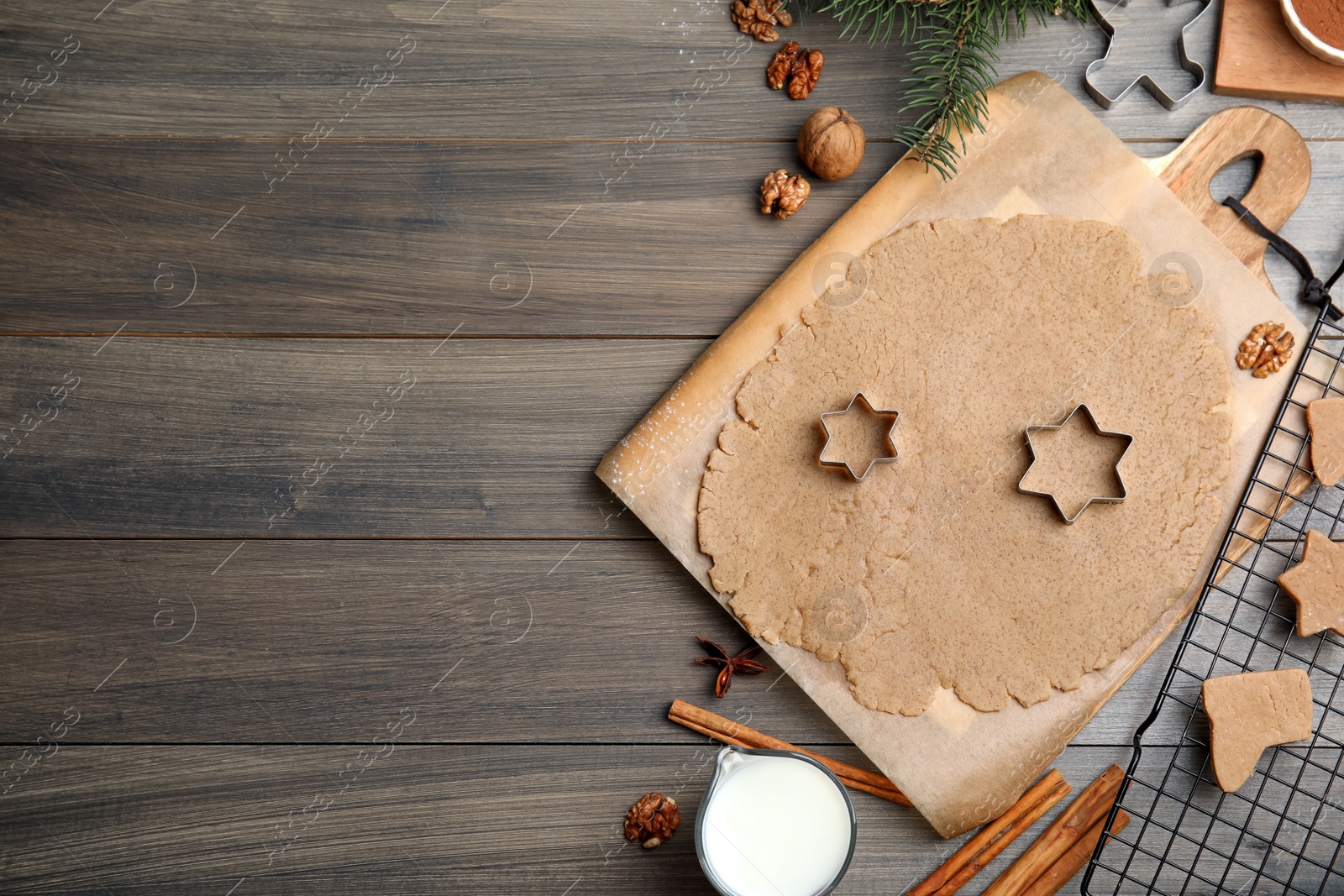 Photo of Homemade Christmas cookies. Flat lay composition with dough on wooden table, space for text