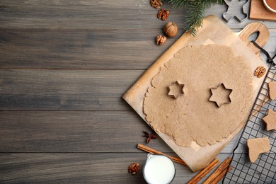 Homemade Christmas cookies. Flat lay composition with dough on wooden table, space for text