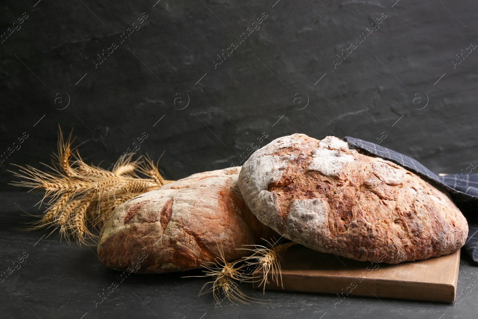Photo of Tasty freshly baked bread on black table