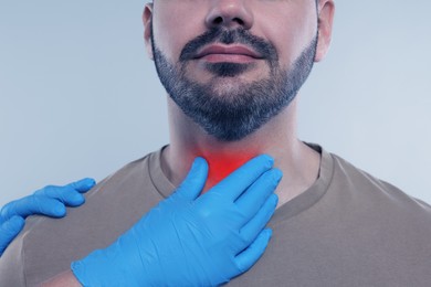 Image of Endocrinologist examining thyroid gland of patient on grey background, closeup