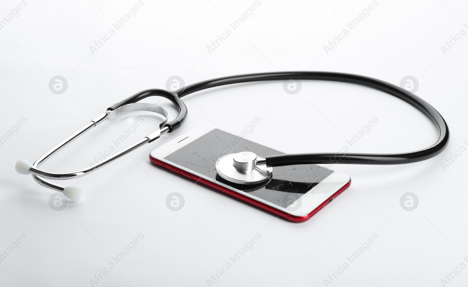 Photo of Modern smartphone with broken display and stethoscope on white background. Device repair service