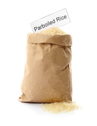 Paper bag with uncooked parboiled rice and card on white background