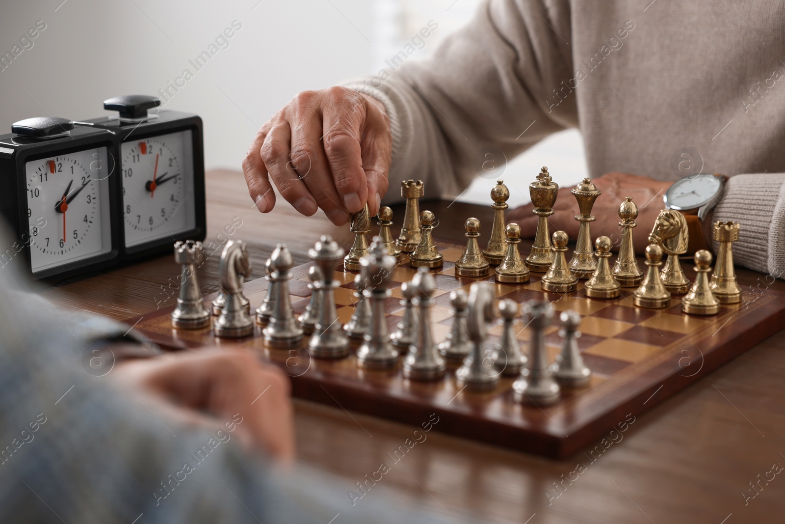 Photo of Men playing chess during tournament at table, closeup