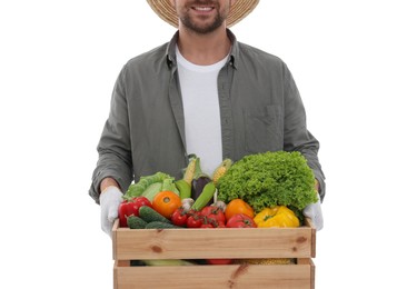 Harvesting season. Happy farmer holding wooden crate with vegetables on white background, closeup