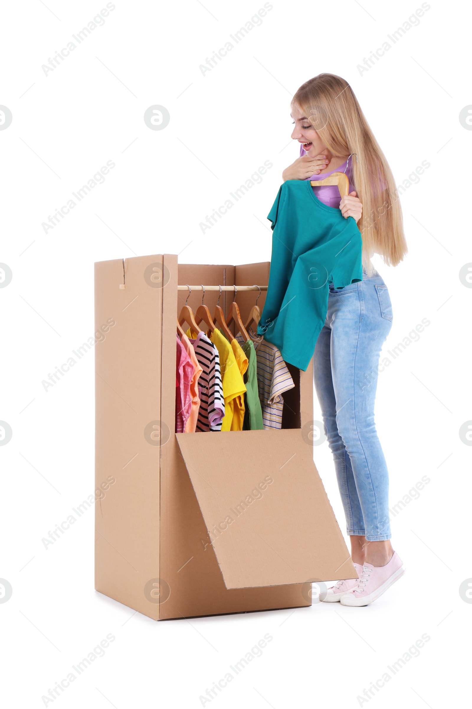 Photo of Young emotional woman near wardrobe box on white background