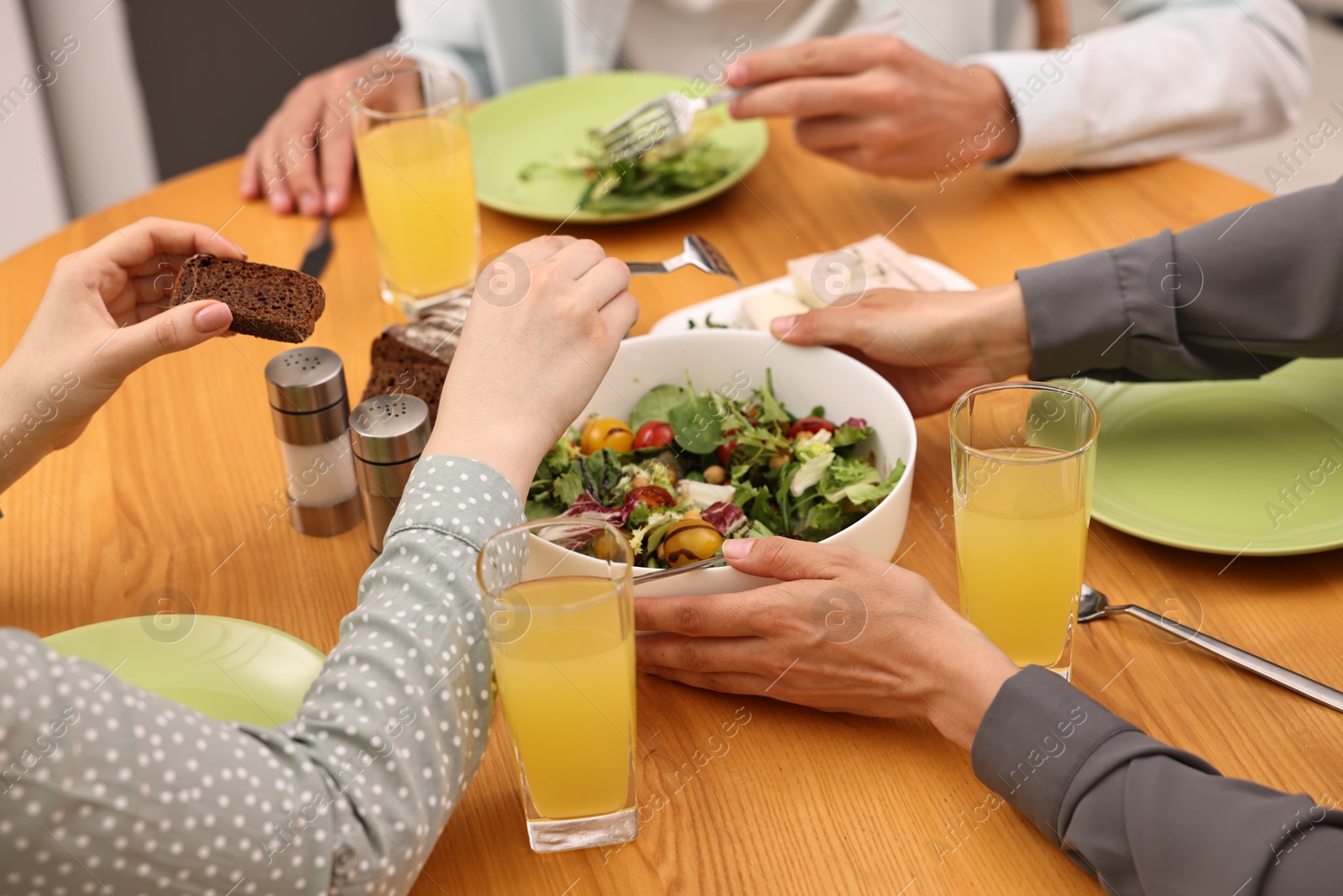 Photo of Friends having vegetarian meal at table in cafe, closeup