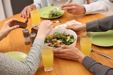 Photo of Friends having vegetarian meal at table in cafe, closeup