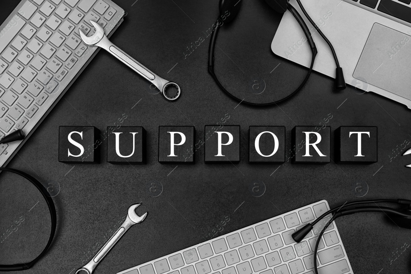 Photo of Cubes with word "SUPPORT" on dark background, flat lay composition. Technical service